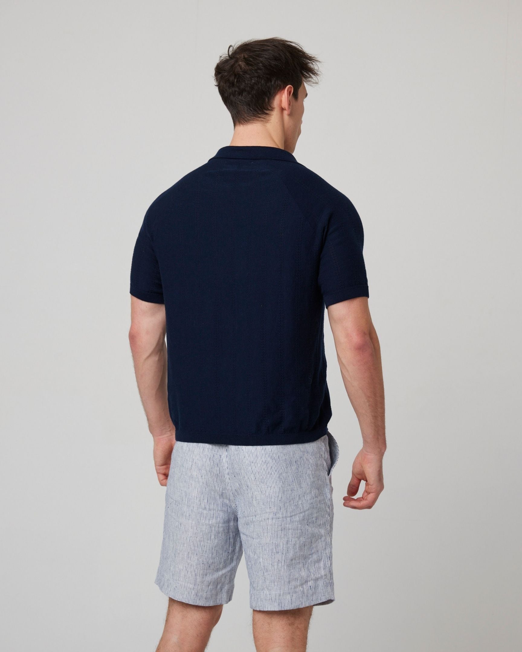 Image of model wearing Alma Polo shirt. 