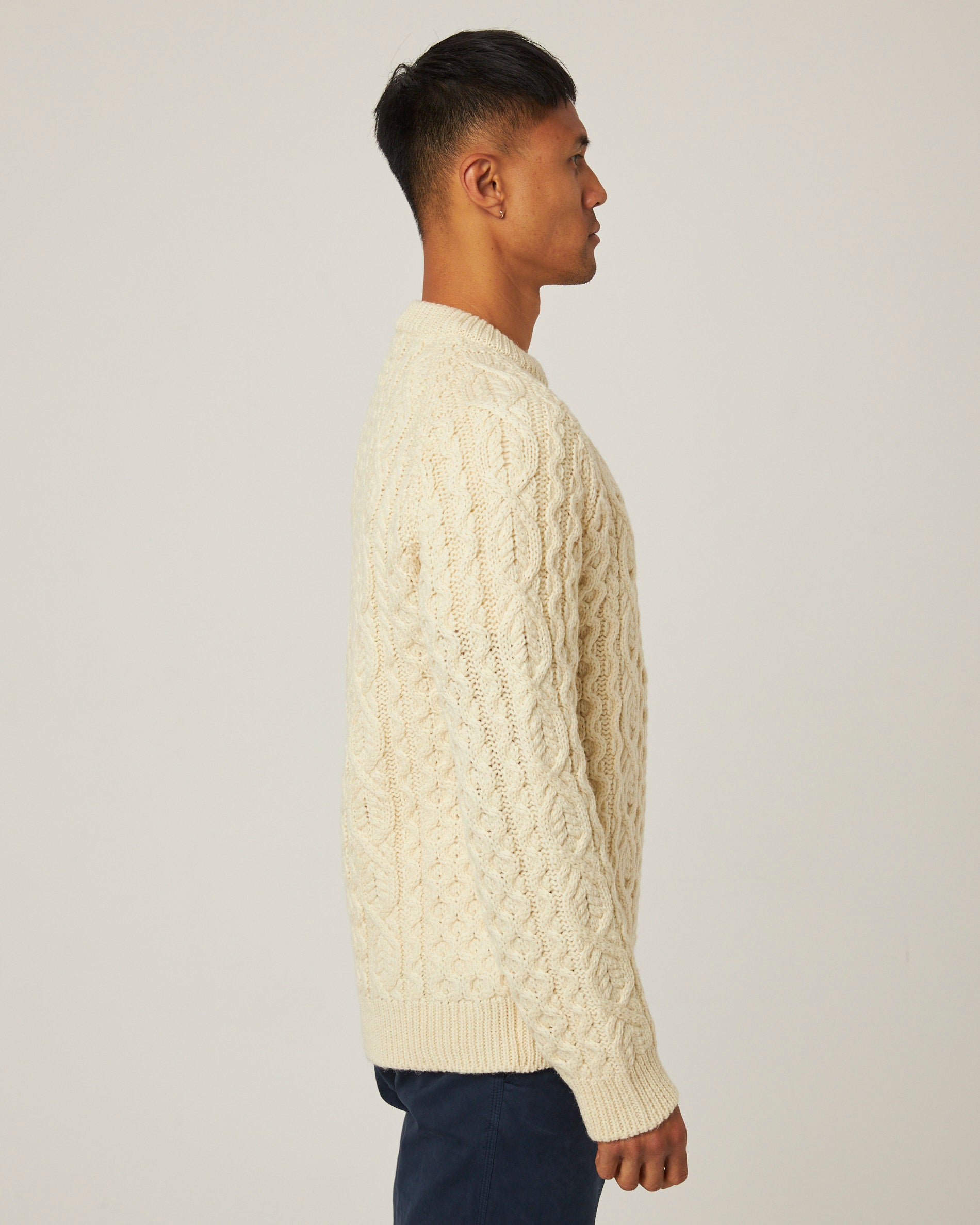 Image of model wearing Hudson Aran Jumper. Model is 6ft1in, chest size 38in and wearing size Large