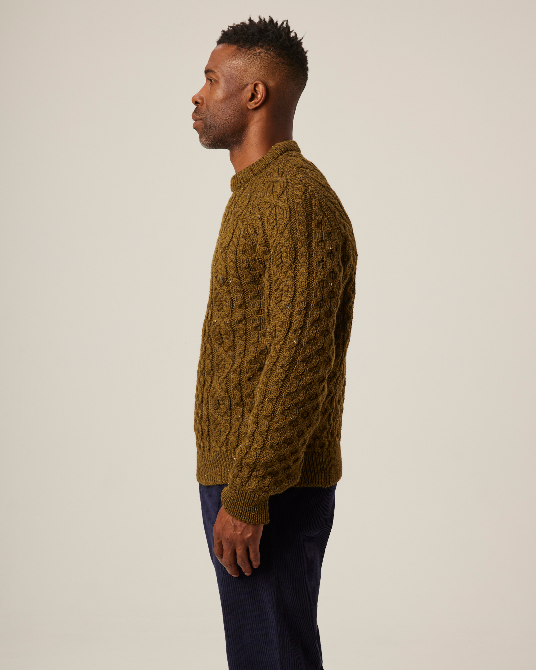 Image of model wearing Hudson Aran Jumper. Model is 6ft1in, chest size 38in and wearing size Medium